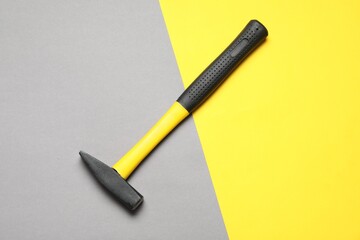 New hammer with rubber handle on color background