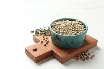 Aromatic spice. White pepper in bowl on white marble table, space for text