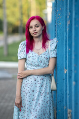 Portrait of a young beautiful red-haired girl outdoors.