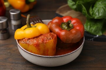 Delicious stuffed bell peppers served on wooden table