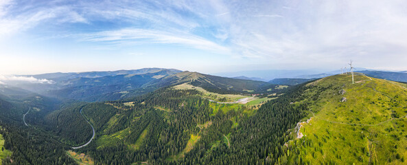 Panoramic view of the Weinebene and Koralpe mountain range in Styria. Wind energy park at the...