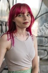 Naklejka premium Portrait of a young beautiful red-haired girl outdoors.