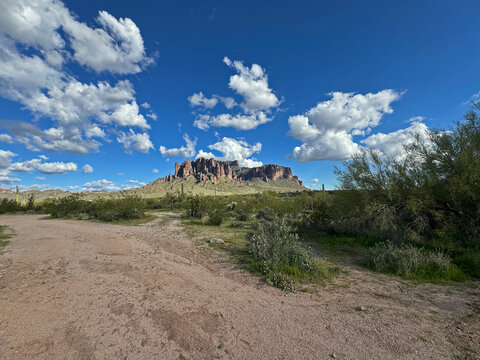 A scenic view of Flatiron in the Superstition mountains in the Lost Dutchman State Park in Apache junction near Phoenix, Arizona with beautiful blue sky and copy space.