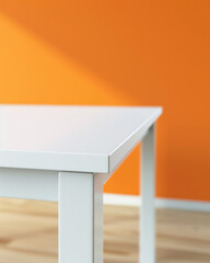 Closeup photo of clean white table with orange room in background.