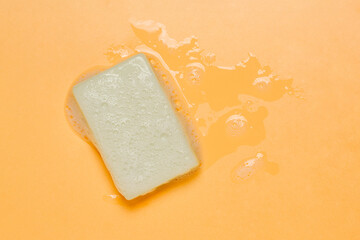 bar of olive oil soap with foam on orange - 786491943