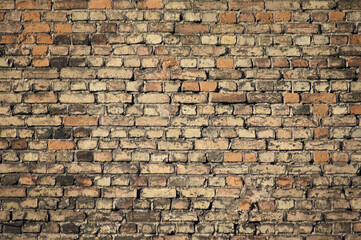 in the photo there is an old brick wall close up