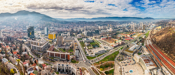 Sarajevo's cityscape unfolds majestically from the viewpoint, offering a stunning backdrop for tourists and locals alike to enjoy. - obrazy, fototapety, plakaty