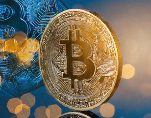 A coin with the letter Bitcoin on it is shown with a blurry background