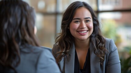An authentic moment of happiness and gratitude as a Hispanic candidate and a businesswoman conclude a fruitful interview.