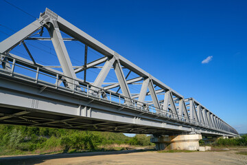 Fototapeta na wymiar Gray metal framework of the bridge. Industrial surface