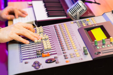 sound engineer, producer hands  working on digital audio mixing console in studio. recording, post production, music production concept - 786517934