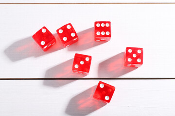 Many red game dices on white wooden table, flat lay