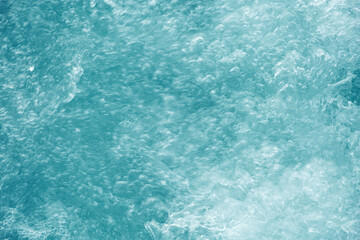Fototapeta na wymiar Abstract transparent water texture, bubbling clear water as textured background, purity and beauty of nature, natural ripples and waves on blue turquoise aquatic surface, nature environment