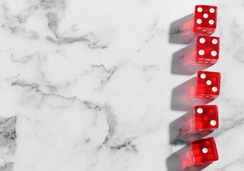 Many red game dices on white marble table, flat lay. Space for text