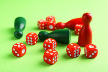 Many red dices and color game pieces on green background