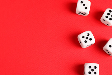Many white game dices on red background, flat lay. Space for text