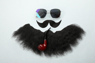 Flat lay composition with artificial moustache and sunglasses on light grey background