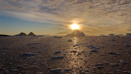 Sunset behind a huge iceberg at Cierva Cove, Antarctica