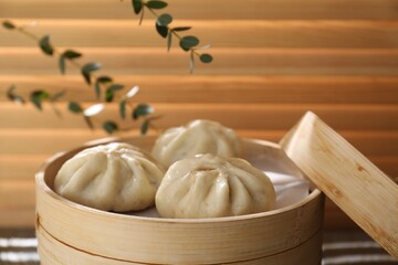 Delicious bao buns (baozi) on table, closeup