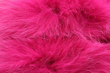 Texture of bright pink faux fur as background, top view