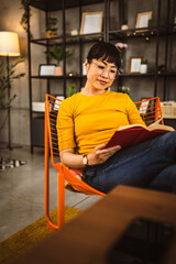 one female mature japanese woman read book at home