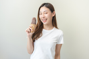 Cheerful enjoy, portrait of happy asian woman have fun with  brunette hair, holding ice cream...