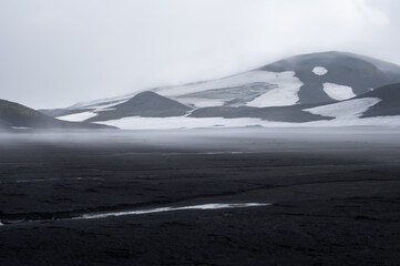 Volcano with snow and black lava on Icelandic highlands at Landmannalaugar, Iceland. Famous...