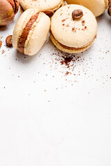 Macaroons with chocolate cream on a light background.