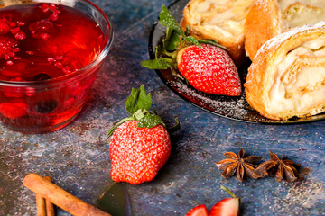 Sliced rolls with custard. The dessert is decorated with fresh strawberries.