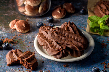 Chocolate shortbread cookies. Dark background.