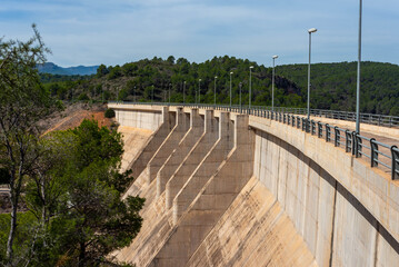 Side view from the top of a dry concrete river dam