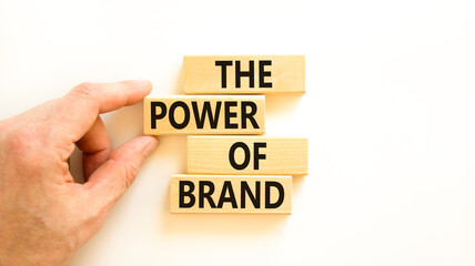 The power of brand symbol. Concept words The power of brand on beautiful wooden block. Beautiful white table white background. Businessman hand. Business the power of brand concept. Copy space.