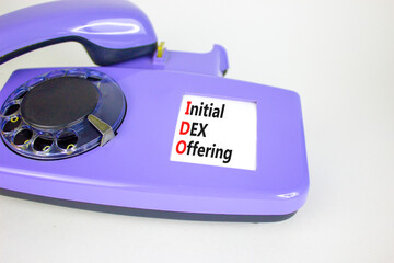 IDO initial DEX offering symbol. Concept words IDO initial DEX offering on beautiful old disk...