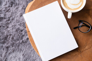Obraz na płótnie Canvas blank book mockup on coffee table with decorations and grey rug
