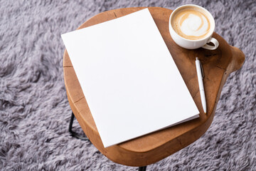 blank magazine mockup on coffee table with cappuccino, pen and grey rug