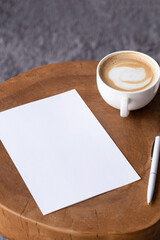 blank notepaper mockup on coffee table with cappuccino, pen and grey rug