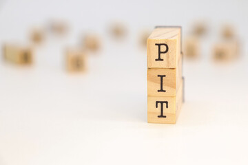 Acronym PIT on wooden cubes concept of business. Annual tax settlement in Poland.