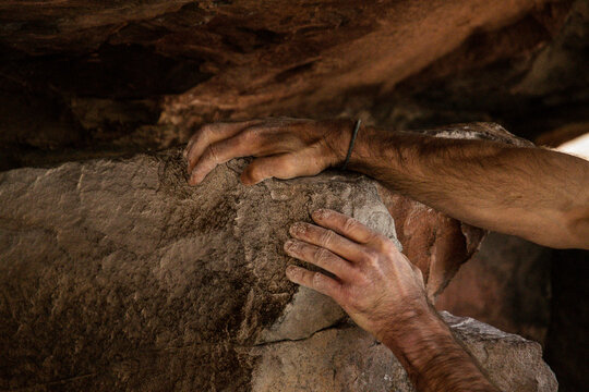 Hands of a bouldering climber