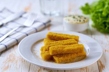 Golden roast Fish Sticks Fingers with sauce. Food recipe background. Close up.