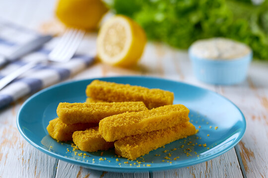 Golden roast Fish Sticks Fingers with sauce. Food recipe background. Close up.
