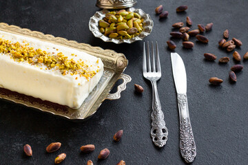 Traditional Turkish Maras Ice Cream, on a silver tray with cutlery and pistachios