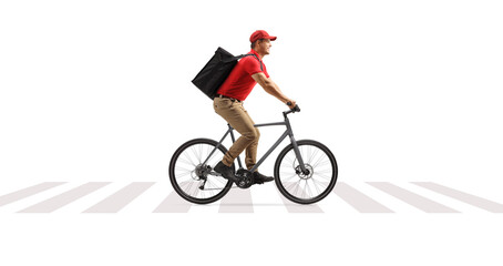 Food delivery guy on a bicycle riding at a pedestrian crossing