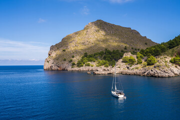 Seascape. Beautiful bay with blue sea, white yacht among the beautiful mountains of Mallorca on the coast of Sa Calobra, Mediterranean Sea, Mallorca, Mallorca, Balearic Islands