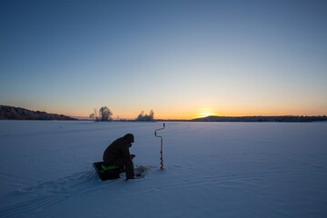 winter fishing in the north, frost at sunset