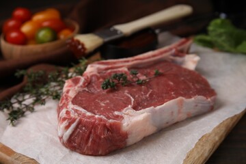 Raw meat and thyme on table, closeup