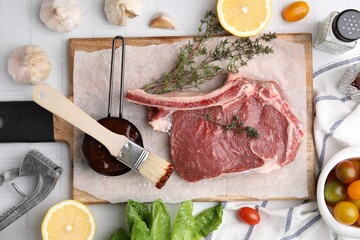 Flat lay composition with raw meat, thyme and marinade on white tiled table