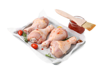Marinade, brush, raw chicken drumsticks, rosemary and tomatoes isolated on white