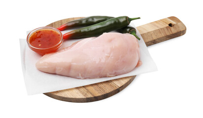 Marinade, basting brush, raw chicken fillets and chili peppers isolated on white