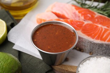 Tasty fish marinade and products on table, closeup