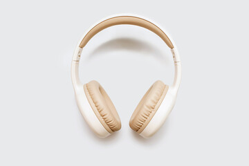 Bluetooth headphones on a white background with free space for text. Close-up of white wireless...